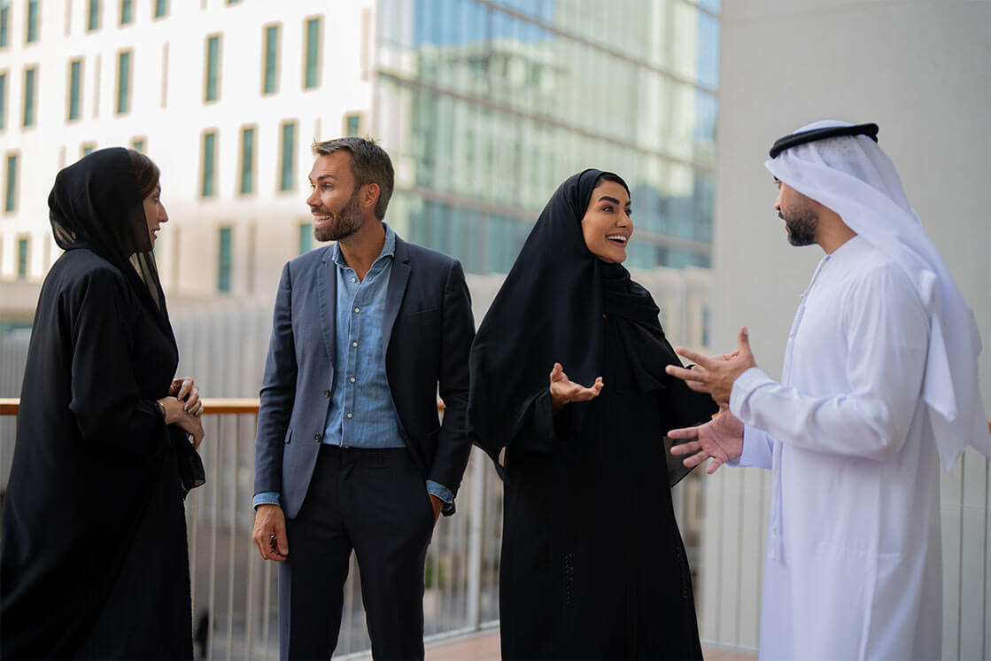 Students at the EMBA Dubai program talking and laughing